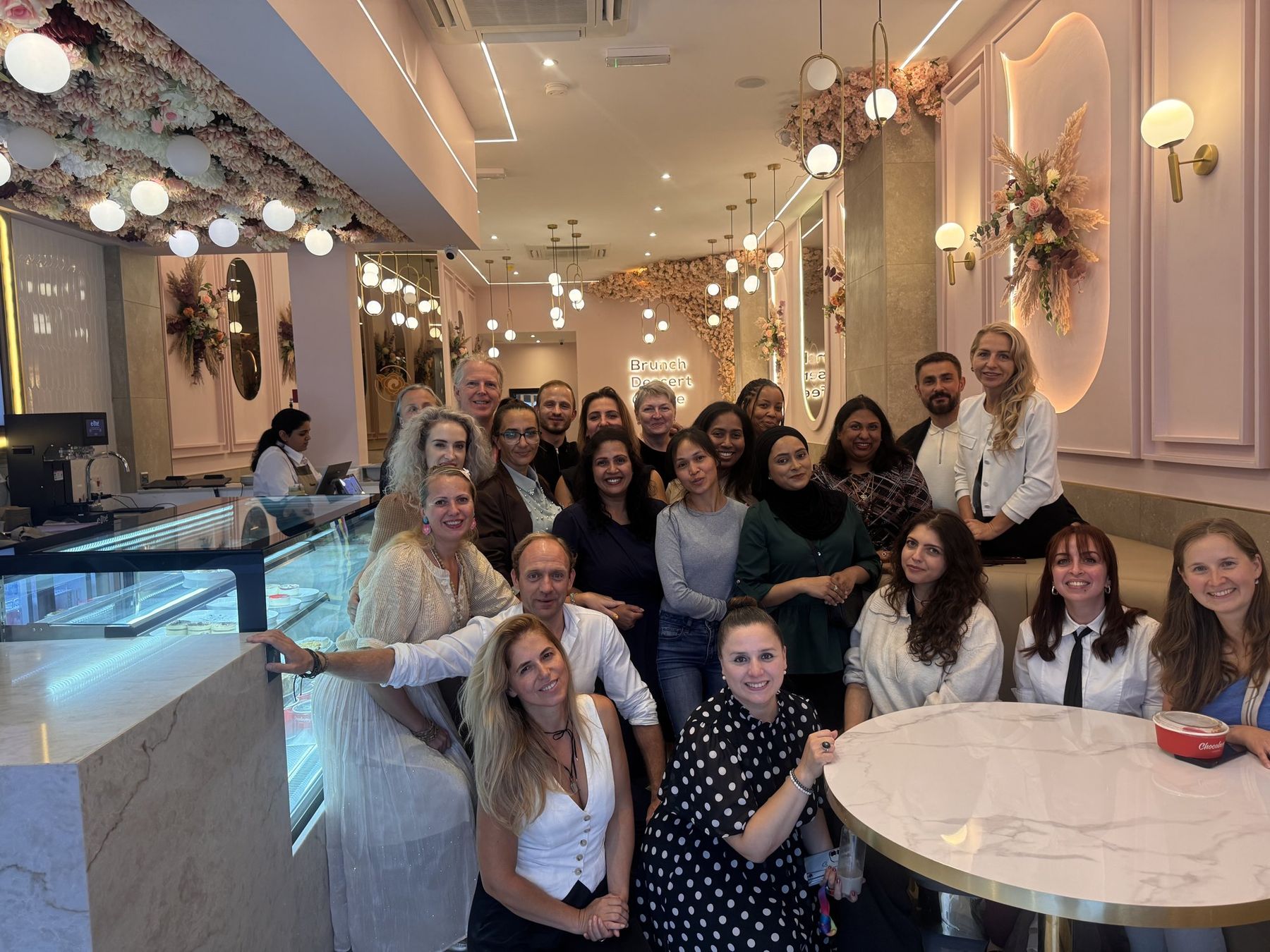Daniel Fitzhenry with his Quantum Leap team, a large group gathered in a London café