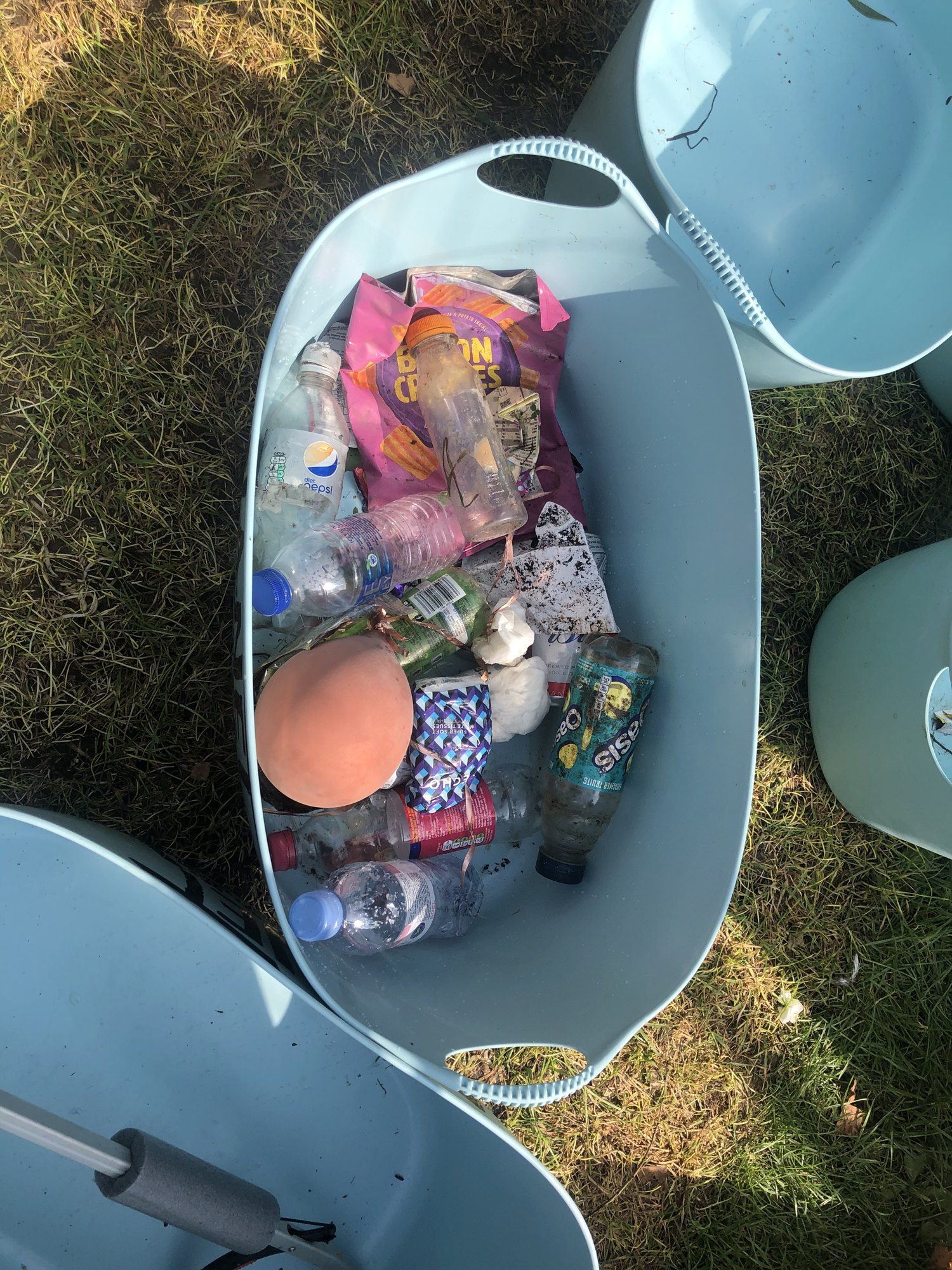 A bucket full of bottles, cans and crisp packets pulled from the river