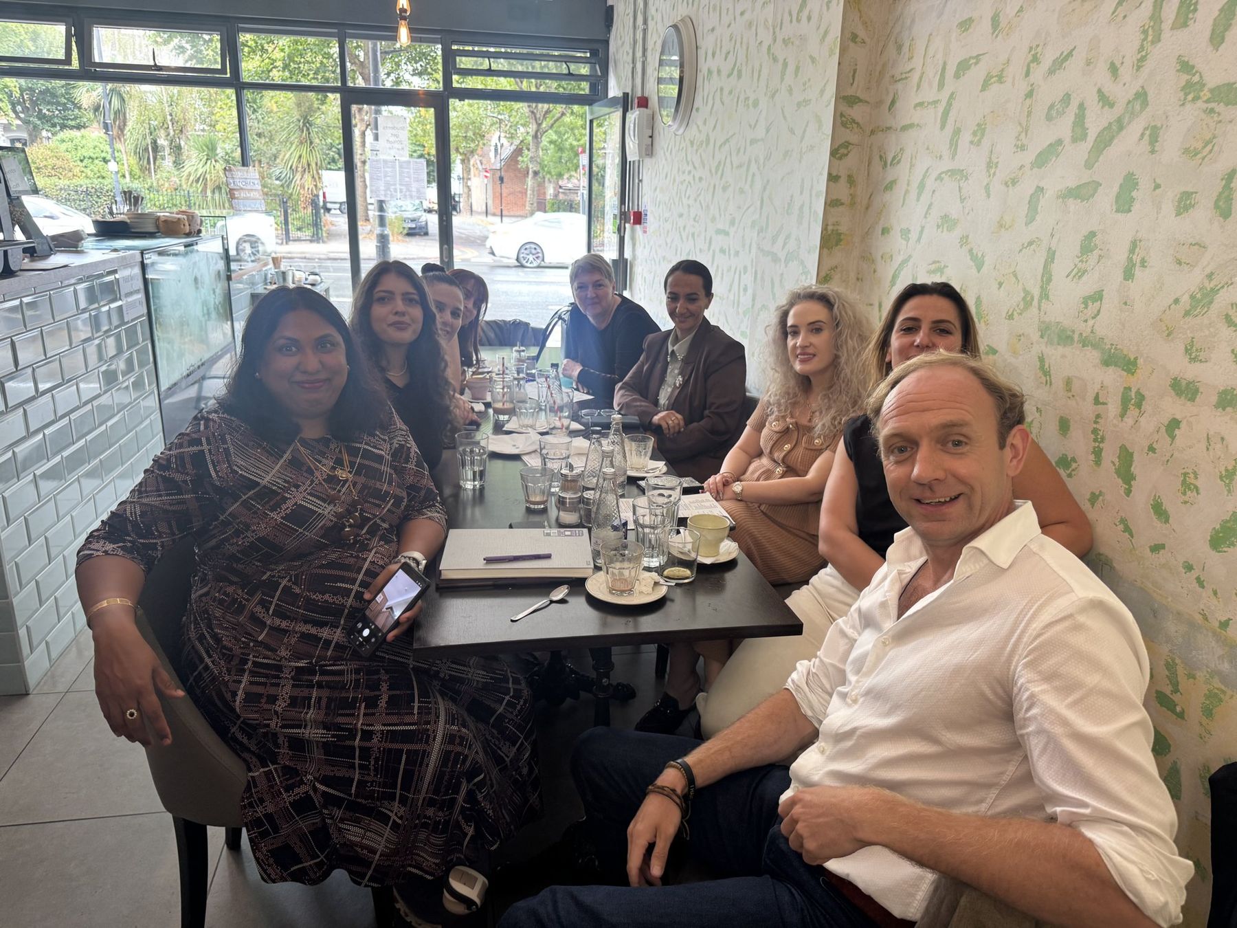 Daniel Fitzhenry meeting with his Quantum Leap team around a café table in London