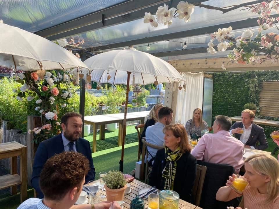 Business leaders in conversation around a breakfast table, Daniel Fitzhenry among them, at The Garden Society, Eastleigh