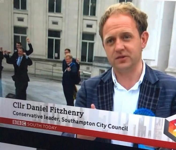 Daniel Fitzhenry interviewed live on BBC South Today on the day of the May 2021 election win, with his team celebrating behind him