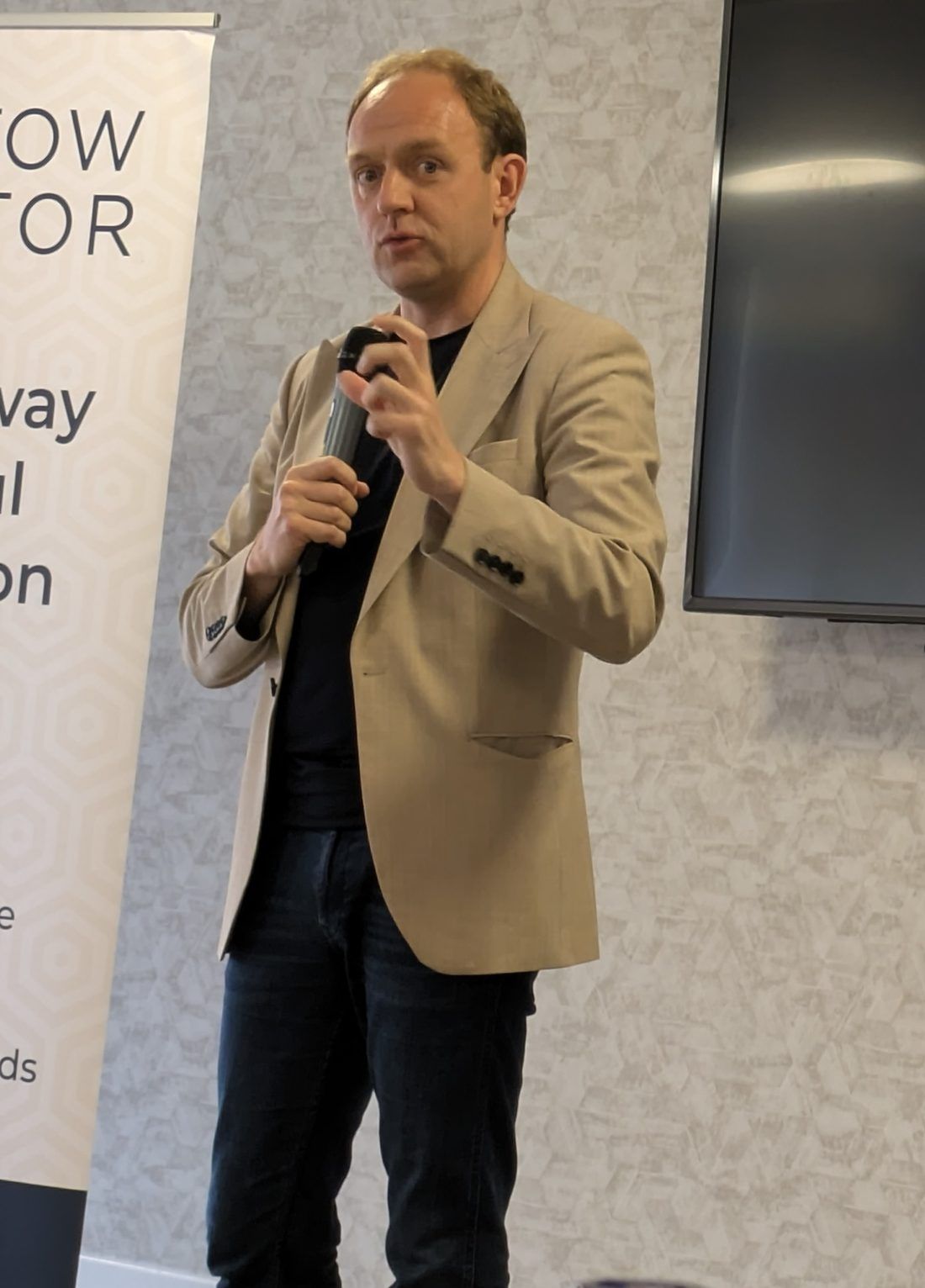 Daniel Fitzhenry mid-talk, microphone in hand