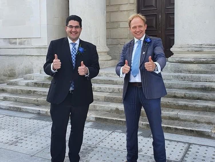 Daniel Fitzhenry and a colleague giving thumbs up on the Civic Centre steps